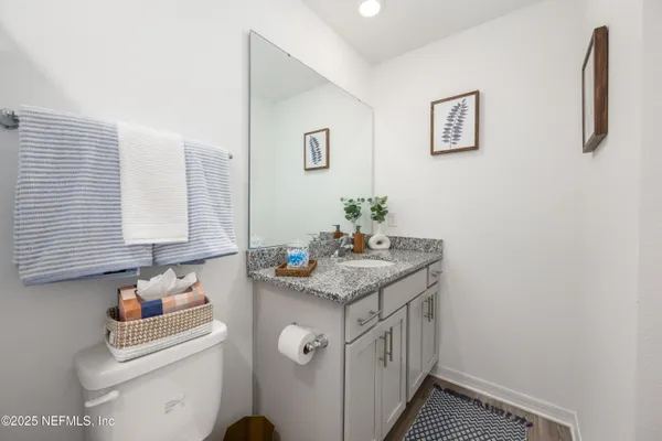 a bathroom with a sink toilet and mirror