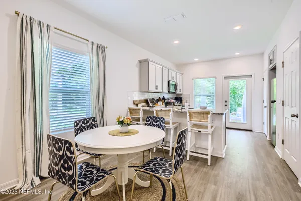 a view of a dining room with furniture and wooden floor