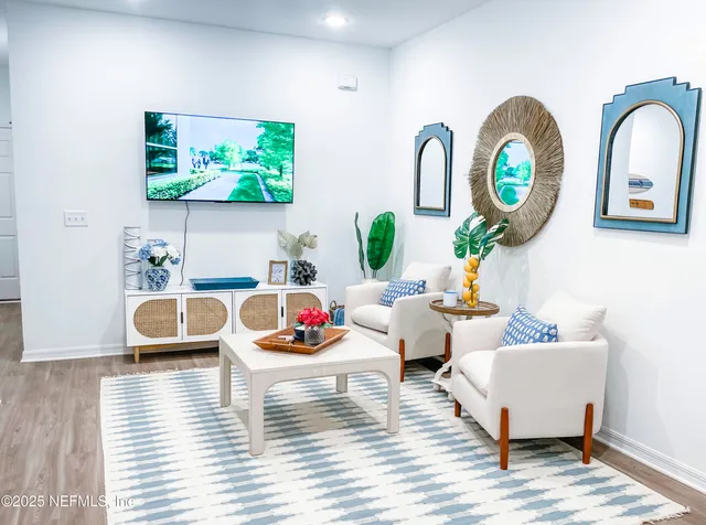 a living room with furniture and a wooden floor