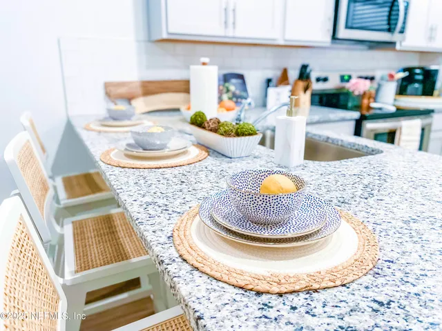 a kitchen with a stove a sink and a dining table