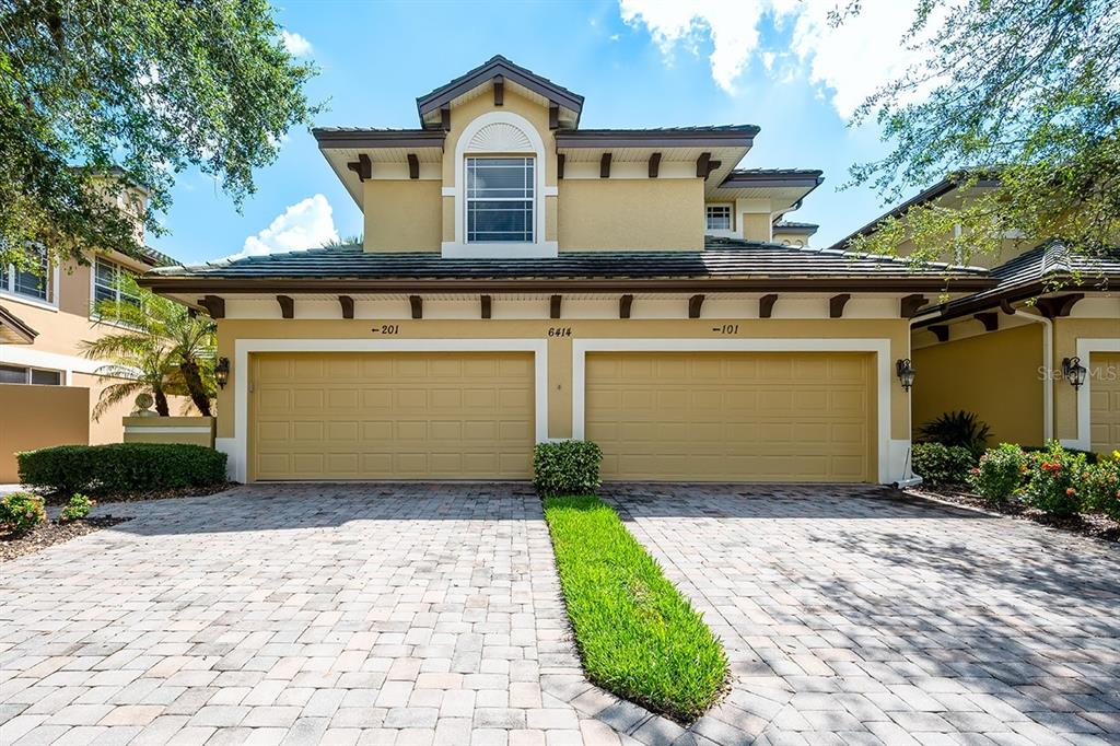 6414 Moorings Point Circle, Unit 201 Lakewood Ranch, FL 34202 - Photo 1 of 1 a front view of a house with a yard