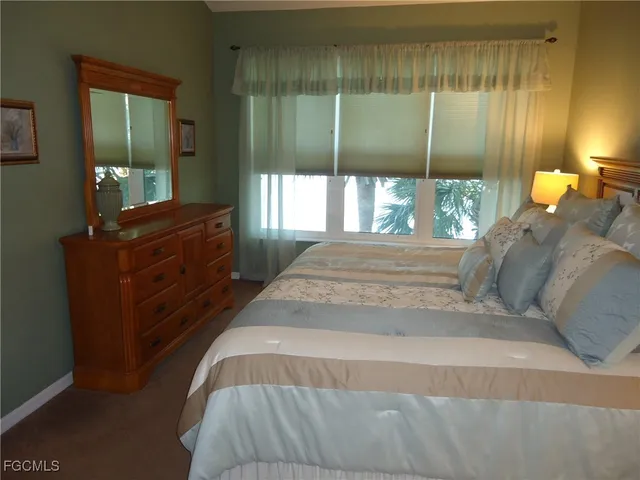 a spacious bedroom with a bed and window