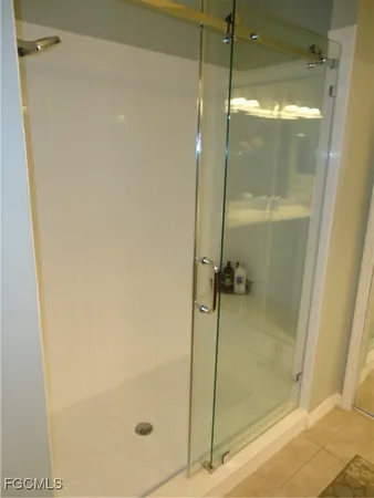 a bathroom with a glass shower door