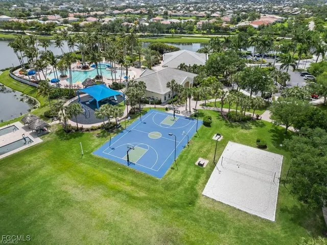 an aerial view of a house with a garden and lake view