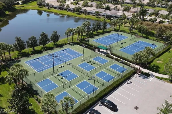 an aerial view of a tennis ground and a mountain view