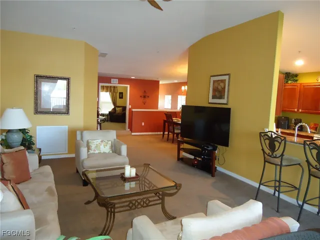 a living room with furniture and a flat screen tv with wooden floor