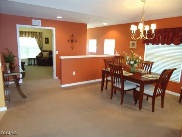 a view of a dining room with furniture and chandelier