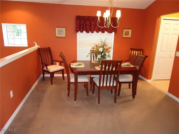 a dining room with furniture and window