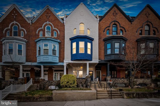 a front view of a residential apartment building with a yard