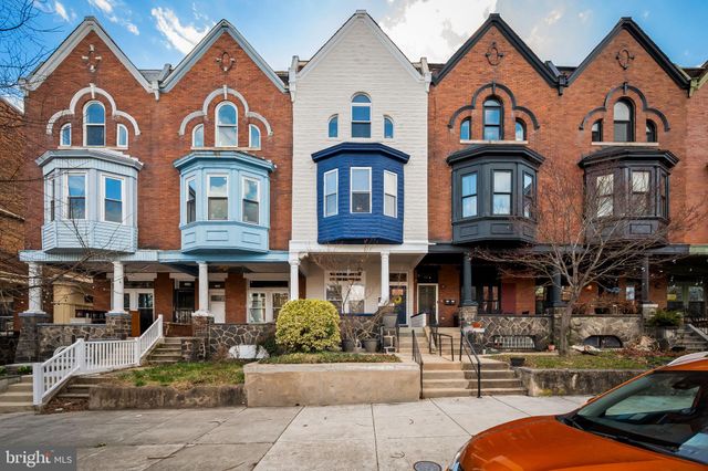 a front view of a residential apartment building with a yard