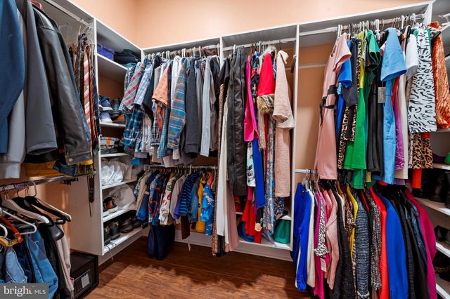 a hallway with a large window and wooden floor