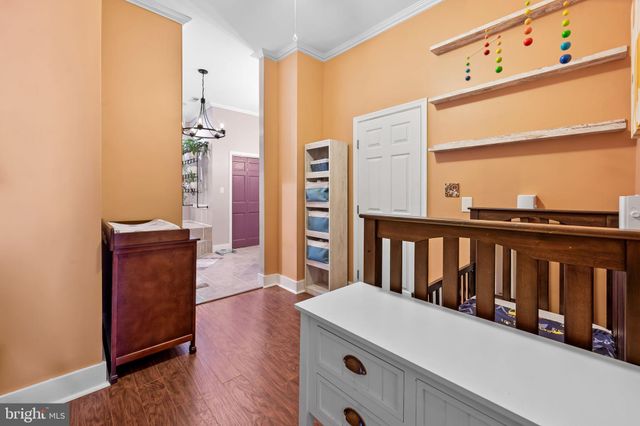 a view of a bedroom with wooden floor