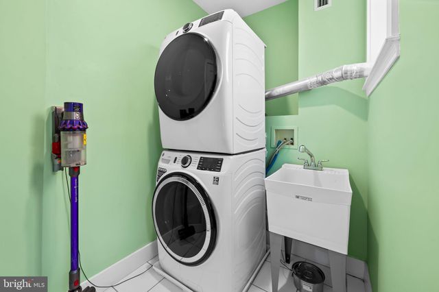 a view of a room with wooden floor and a potted plant