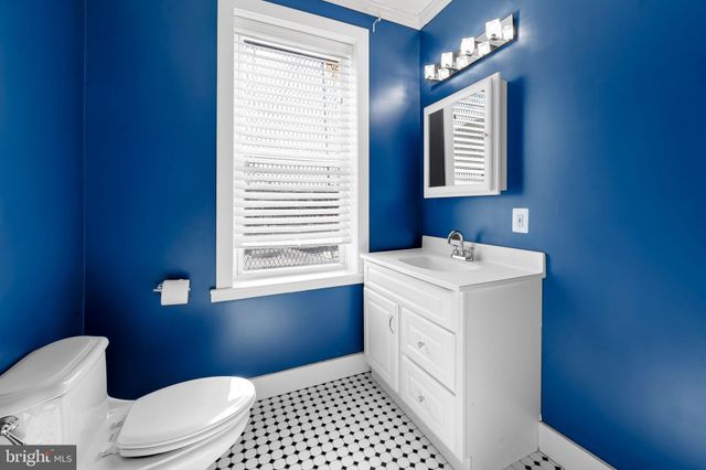 a view of a rooftop deck with couch and chairs