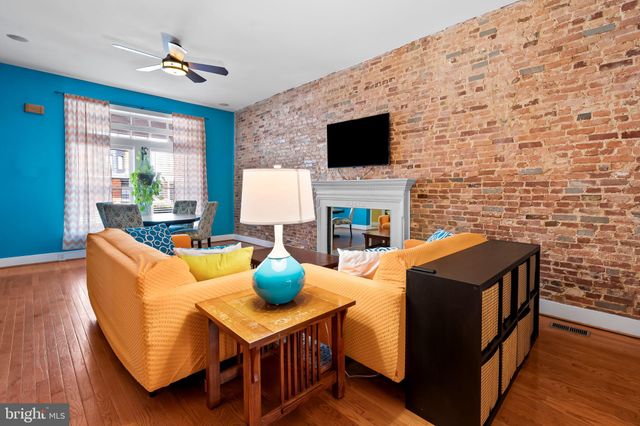a living room with fireplace furniture and a flat screen tv