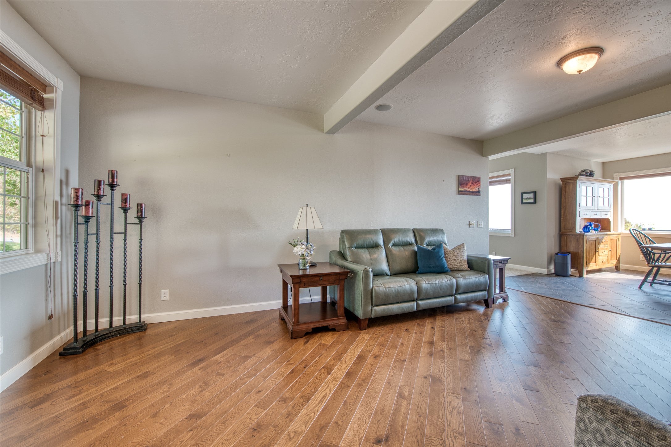16374 Folsom Road Florence, MT 59833 - Photo 56 of 98 Living room with beamed ceiling, a textured ceiling, and wood finished floors