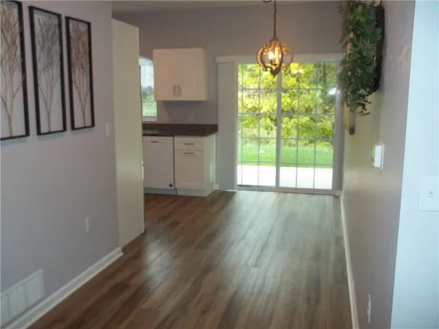 a kitchen with window and wooden floor