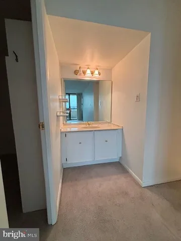 a view of a hallway with a wooden door