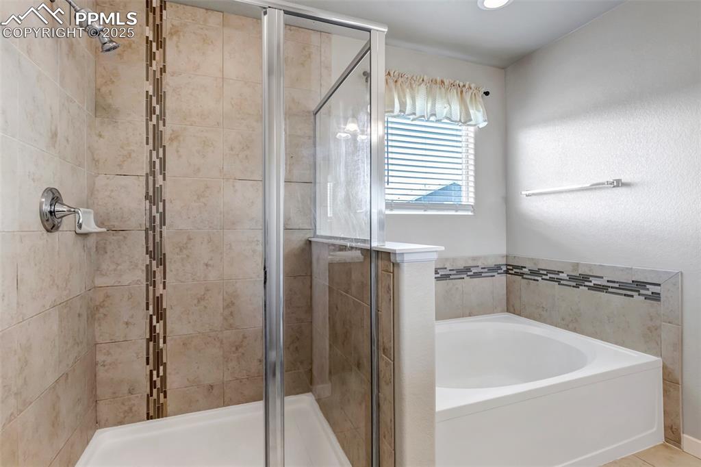 1822 Bulrush Way Colorado Springs, CO 80915 - Photo 24 of 37 a bathroom with a bathtub and a shower