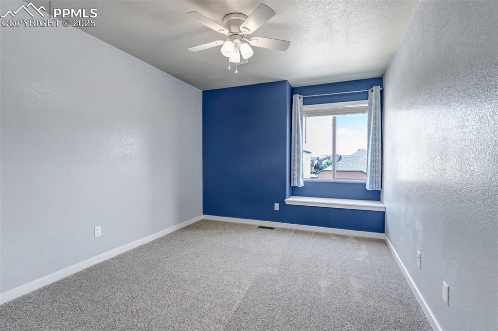 1822 Bulrush Way Colorado Springs, CO 80915 - Photo 25 of 37 an empty room with windows and fan