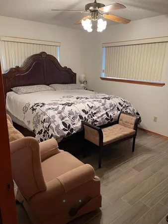 a bedroom with a bed and a chandelier