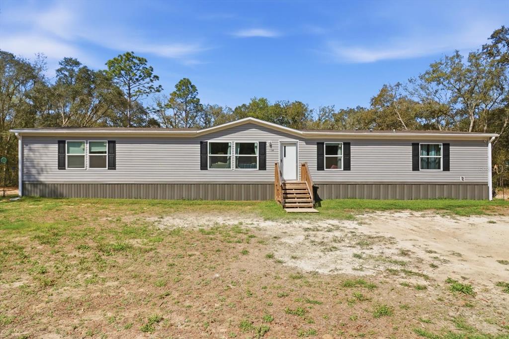 7290 Northeast 110th Avenue Bronson, FL 32621 - Photo 1 of 46 a view of a house with a backyard