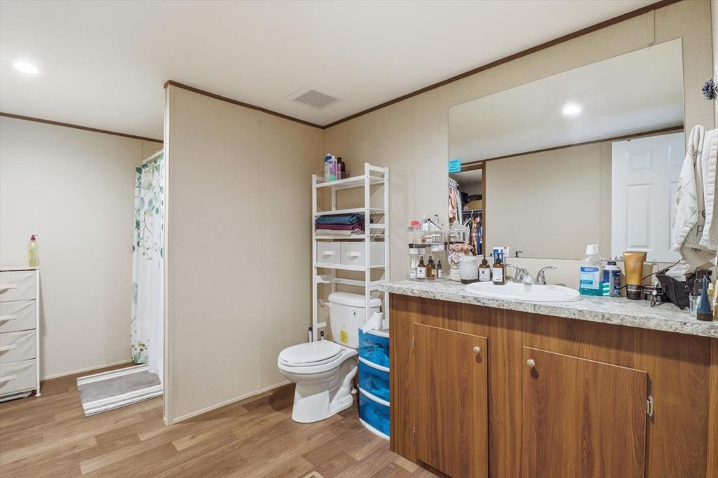 7290 Northeast 110th Avenue Bronson, FL 32621 - Photo 18 of 46 a bathroom with a toilet sink and mirror