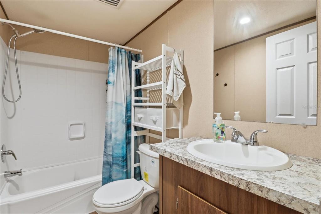 7290 Northeast 110th Avenue Bronson, FL 32621 - Photo 21 of 46 a bathroom with a granite countertop sink toilet and shower