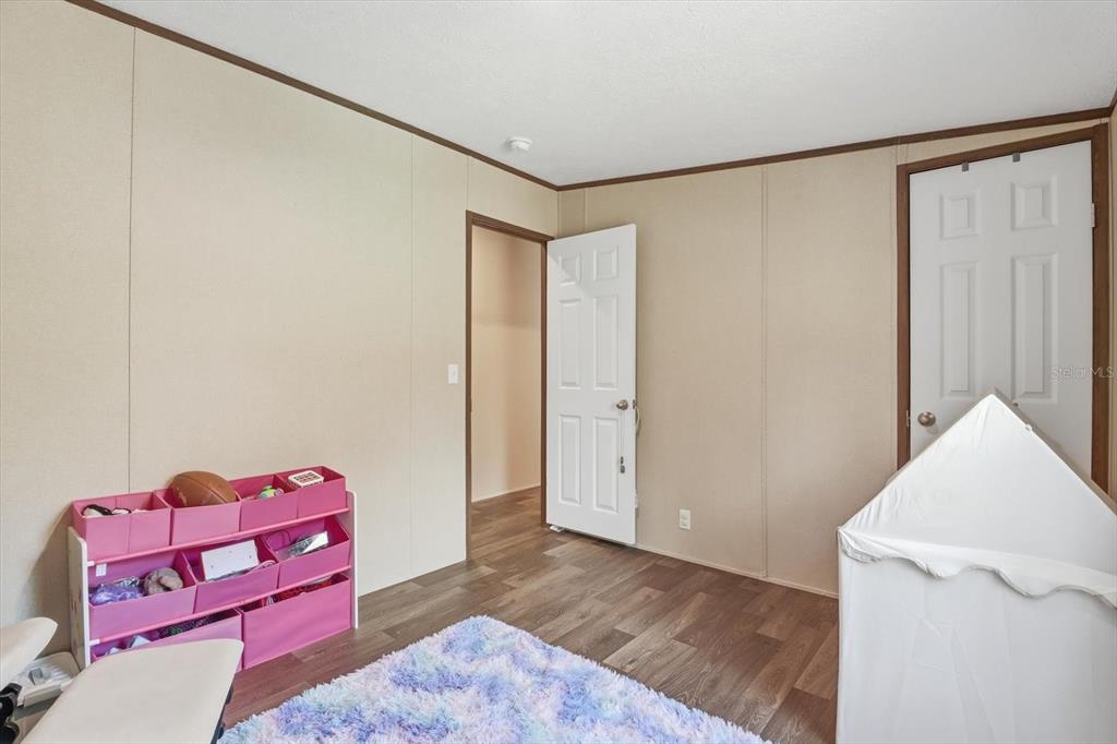7290 Northeast 110th Avenue Bronson, FL 32621 - Photo 23 of 46 a view of a room with toys and wooden floor