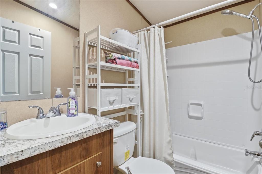 7290 Northeast 110th Avenue Bronson, FL 32621 - Photo 27 of 46 a bathroom with a granite countertop sink toilet and shower