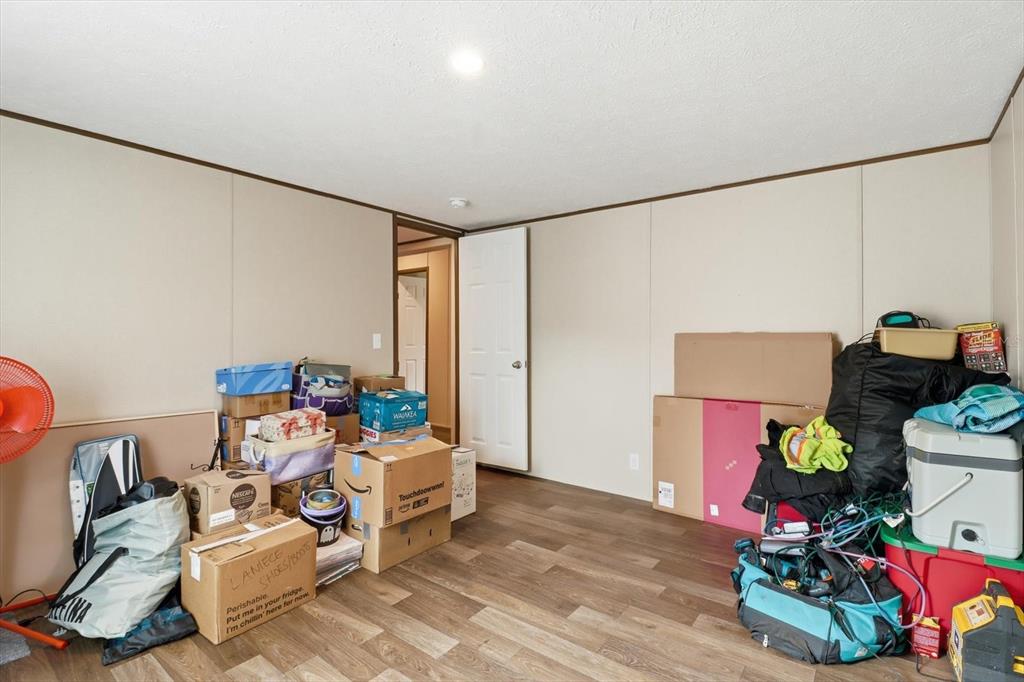 7290 Northeast 110th Avenue Bronson, FL 32621 - Photo 29 of 46 a bedroom with furniture and a wooden floor