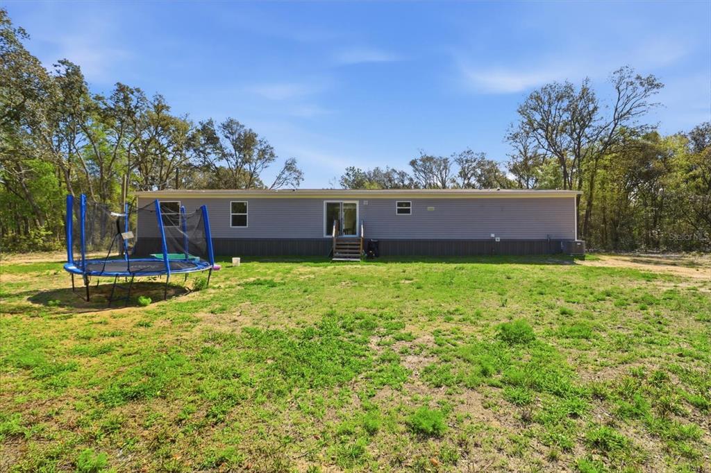 7290 Northeast 110th Avenue Bronson, FL 32621 - Photo 32 of 46 a view of a house with a big yard