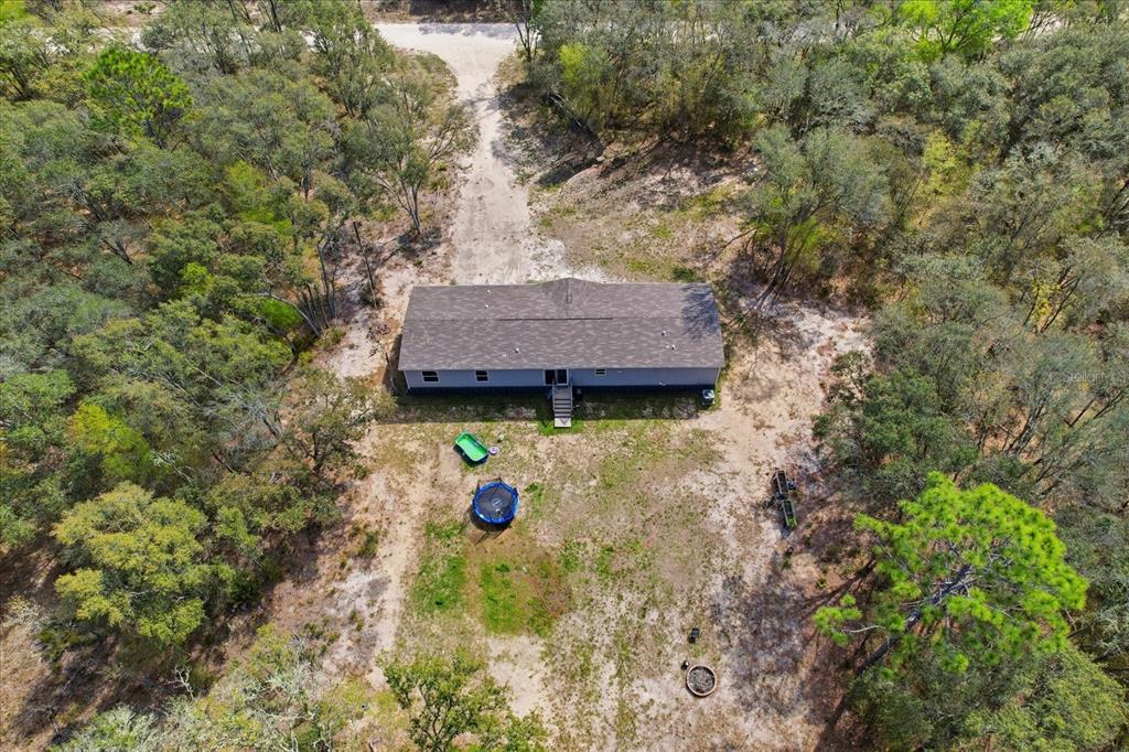7290 Northeast 110th Avenue Bronson, FL 32621 - Photo 41 of 46 a view of a wooden house with a yard