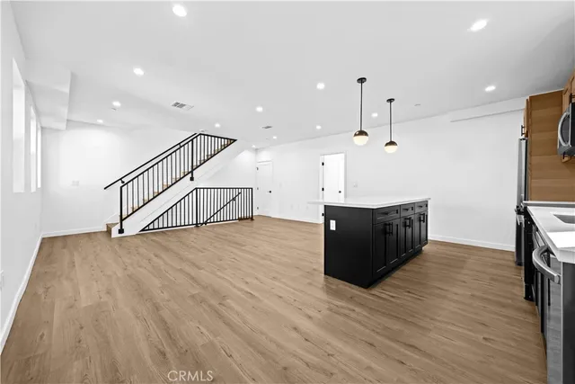 a view of kitchen and hall with wooden floor