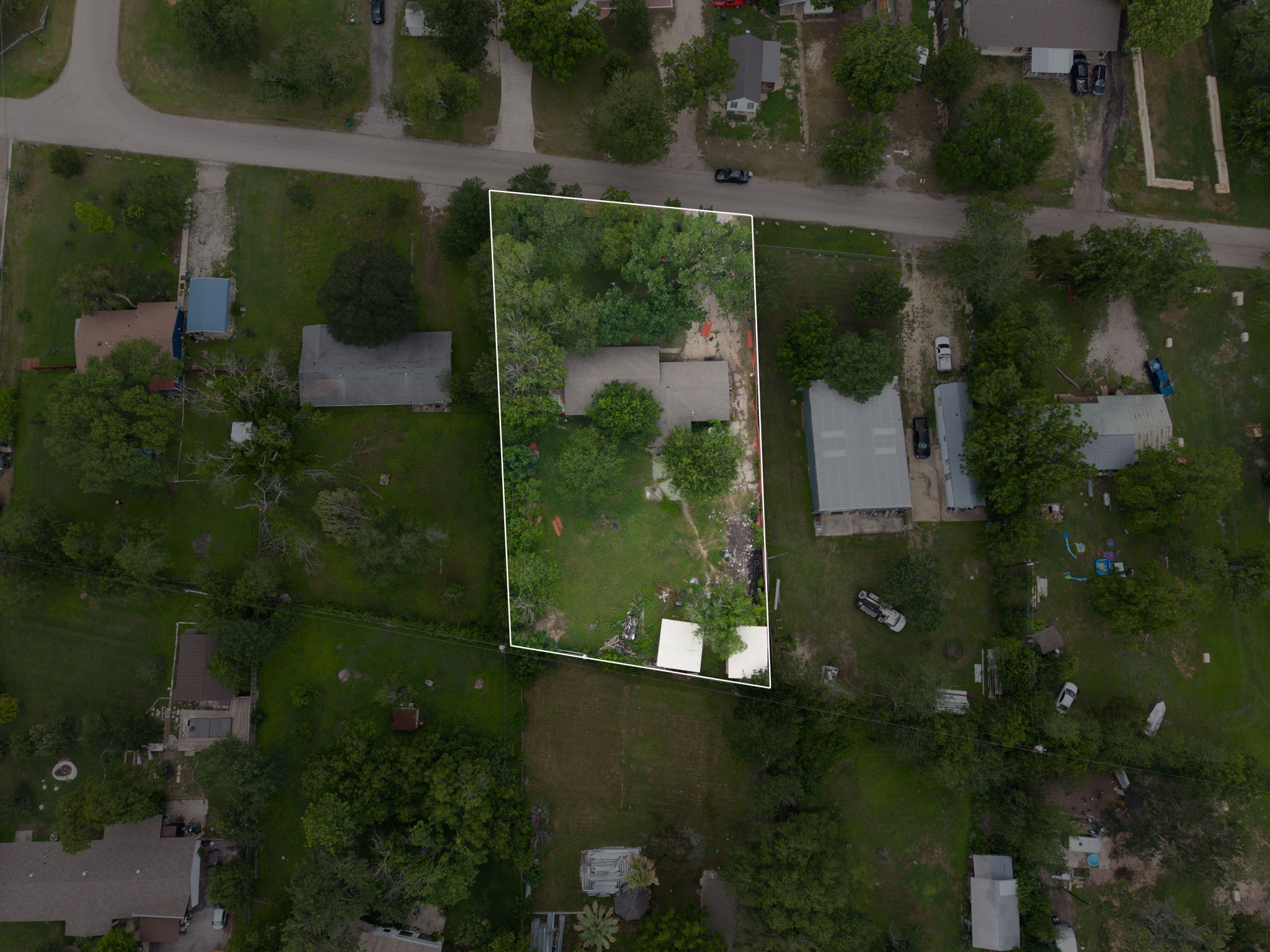 6803 Viewing Place Austin, TX 78719 - Photo 4 of 20 An aerial perspective showcases the extensive lot with mature trees and ample space for outdoor living.
