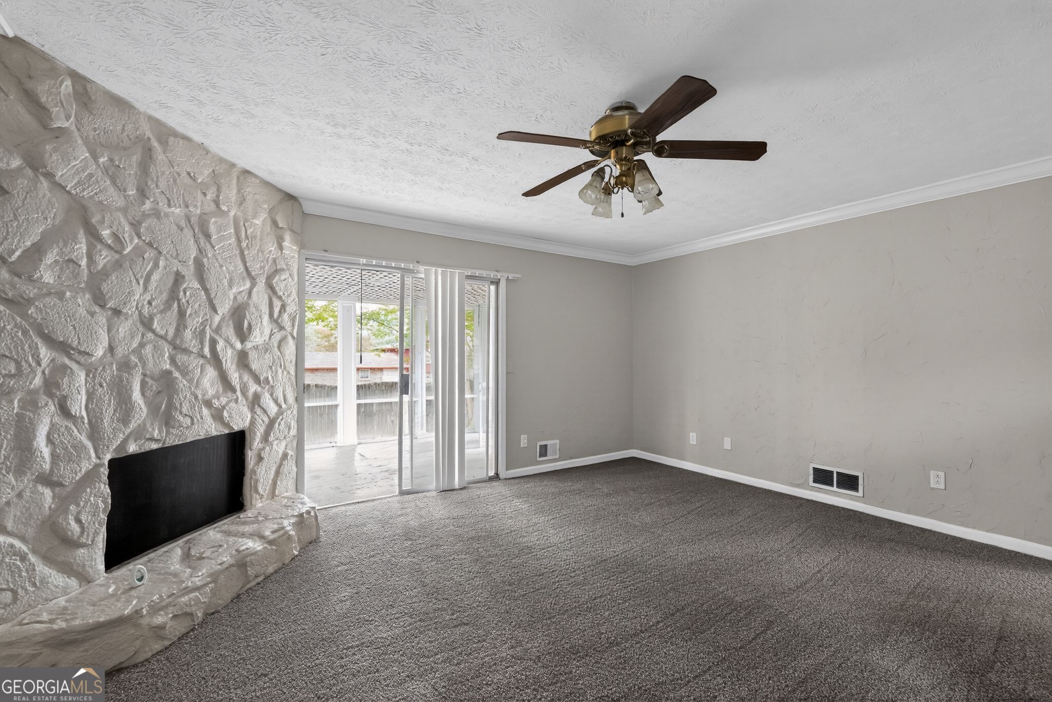 3285 Old Salem Road Southeast Conyers, GA 30013 - Photo 20 of 33 a view of empty room with fireplace and fan