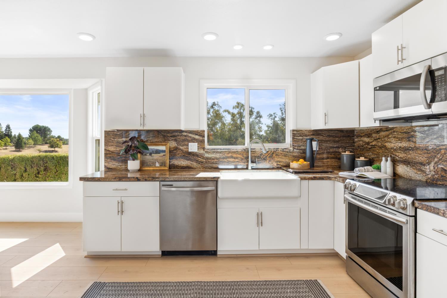 2495 Meadow Creek Road Lincoln, CA 95648 - Photo 40 of 94 a kitchen with stainless steel appliances granite countertop a stove a sink and a microwave