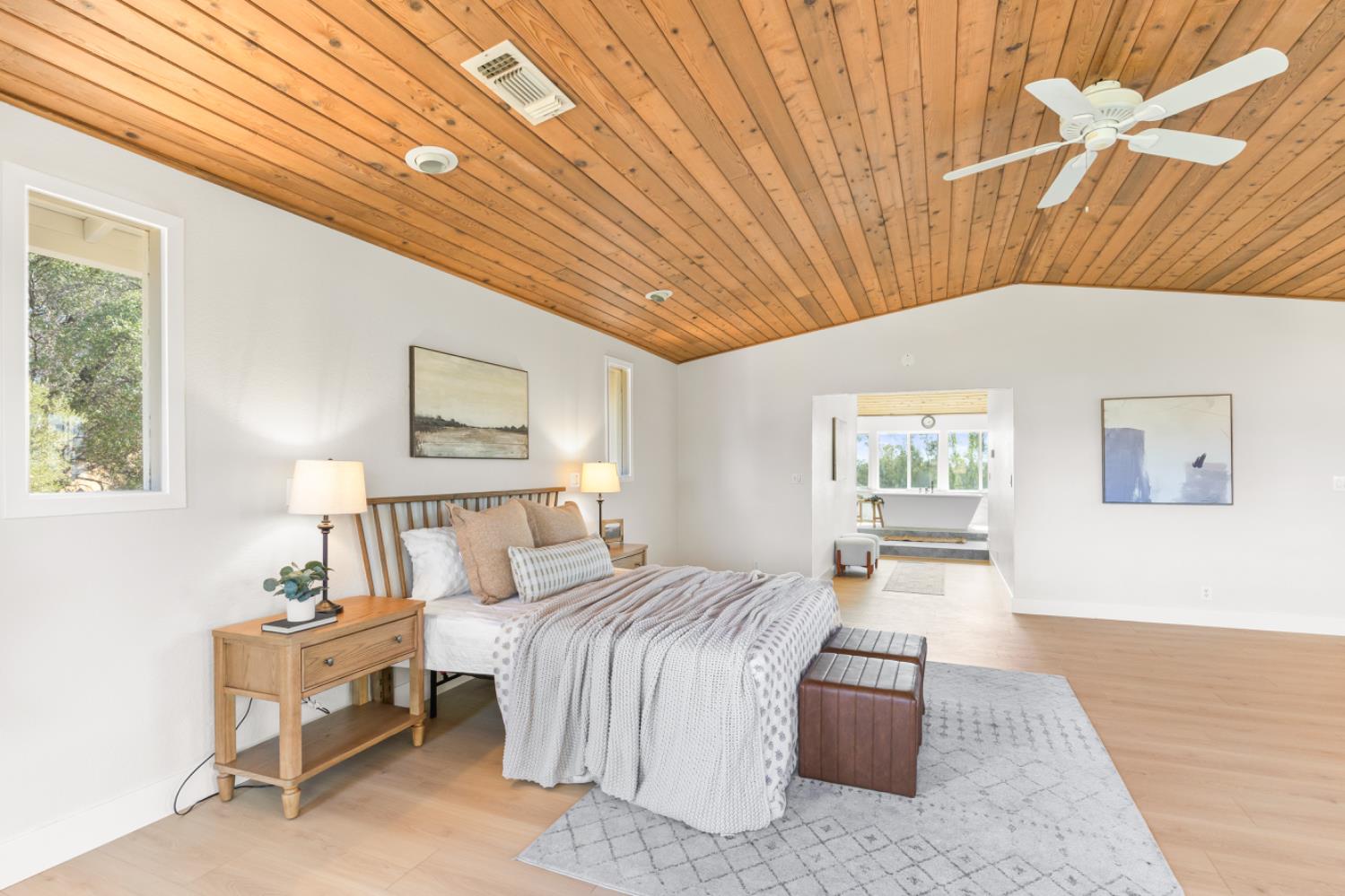 2495 Meadow Creek Road Lincoln, CA 95648 - Photo 51 of 94 a spacious bedroom with a bed and wooden floor