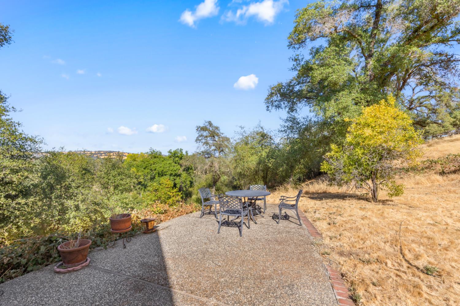 2495 Meadow Creek Road Lincoln, CA 95648 - Photo 69 of 94 a view of a patio with table and chairs and potted plants