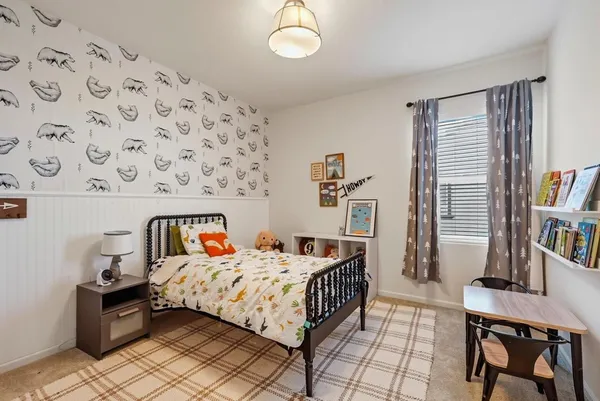 a bedroom with a bed and a dresser in it