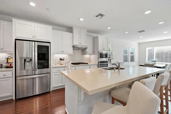 a kitchen with a table and chairs