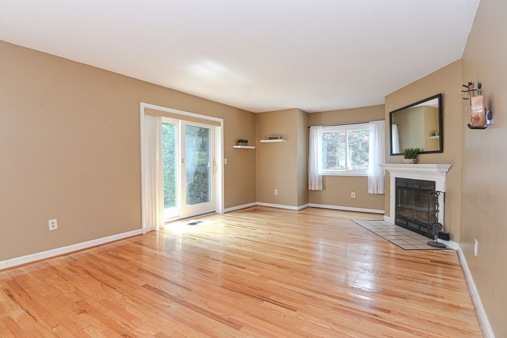 9 Crown's Way, Unit 9 Uxbridge, MA 01569 - Photo 14 of 40 a view of an empty room with wooden floor and a window