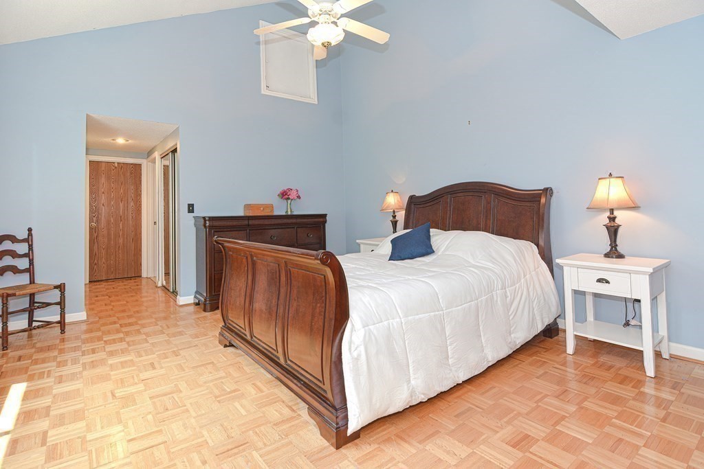 9 Crown's Way, Unit 9 Uxbridge, MA 01569 - Photo 16 of 40 a bed room with a bed and a chandelier