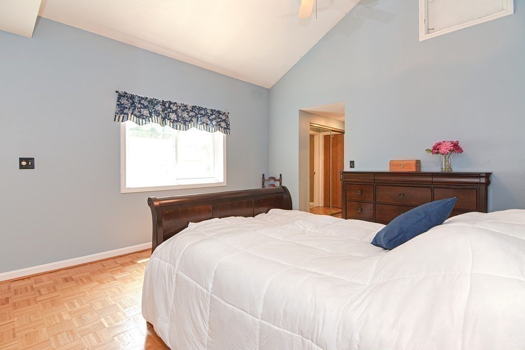 9 Crown's Way, Unit 9 Uxbridge, MA 01569 - Photo 17 of 40 a bedroom with a bed and a dresser next to a window