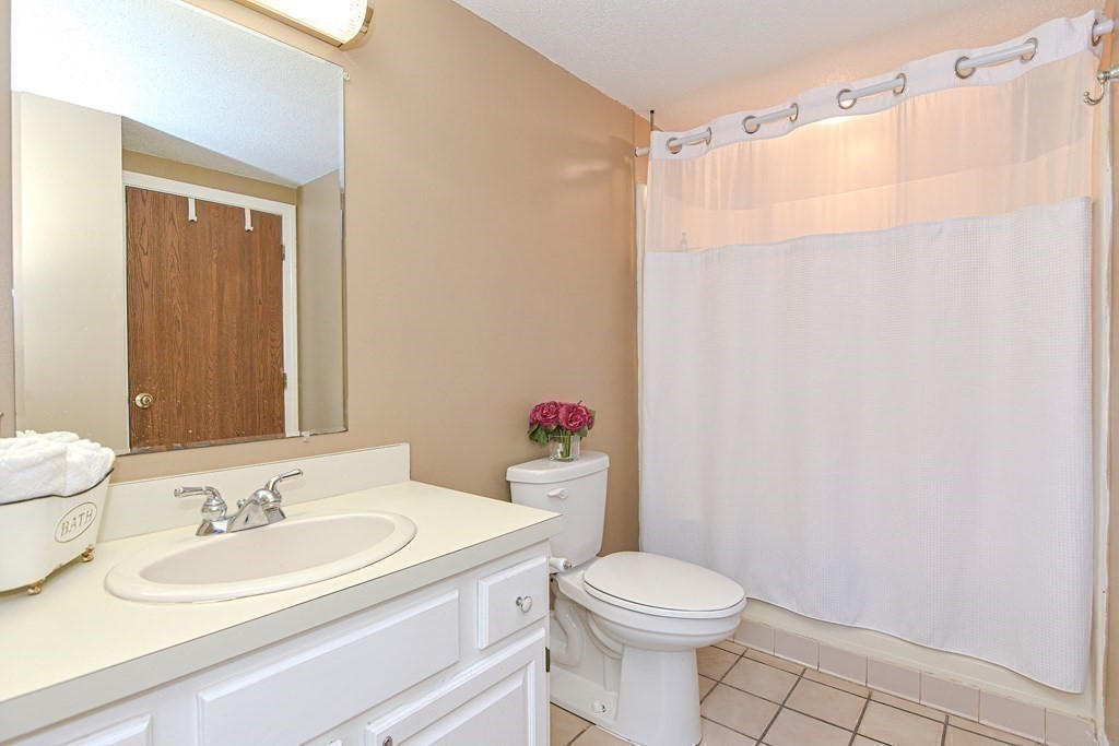 9 Crown's Way, Unit 9 Uxbridge, MA 01569 - Photo 19 of 40 a bathroom with a sink toilet and shower
