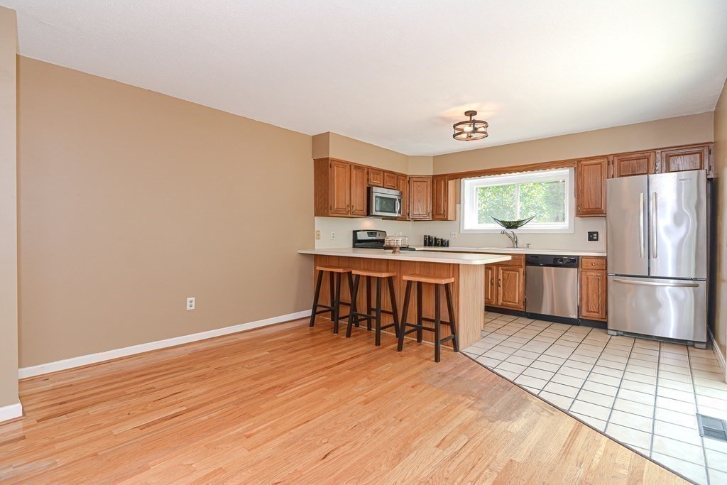 9 Crown's Way, Unit 9 Uxbridge, MA 01569 - Photo 6 of 40 a kitchen with stainless steel appliances a refrigerator and a stove top oven