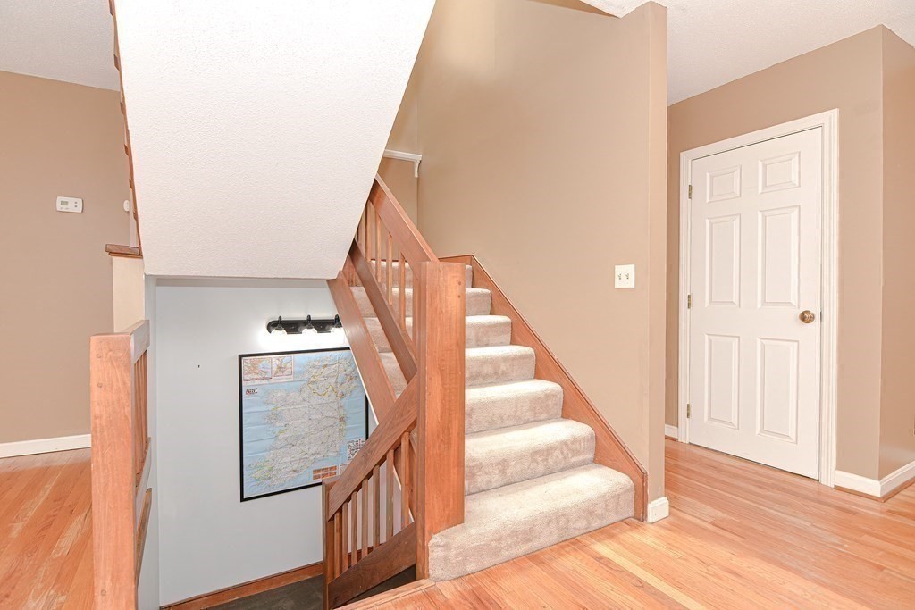 9 Crown's Way, Unit 9 Uxbridge, MA 01569 - Photo 7 of 40 a view of entryway and hall with wooden floor