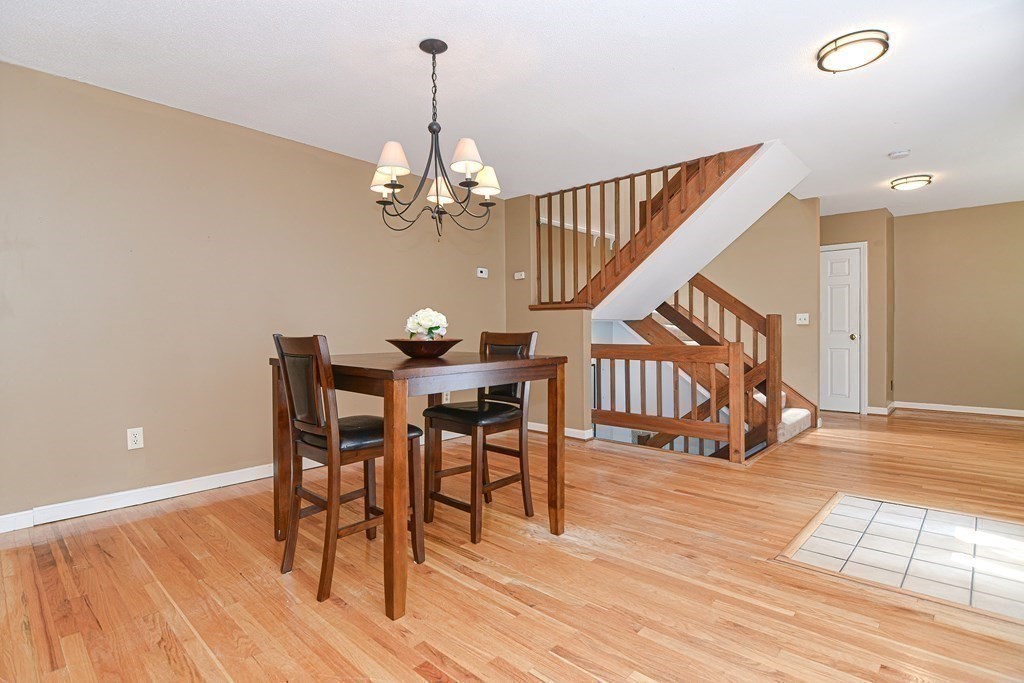 9 Crown's Way, Unit 9 Uxbridge, MA 01569 - Photo 8 of 40 a view of a dining room with furniture and wooden floor