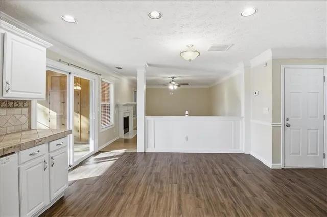 a view of a kitchen with wooden floor and a kitchen