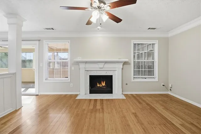 a living room with a fireplace and wooden floor